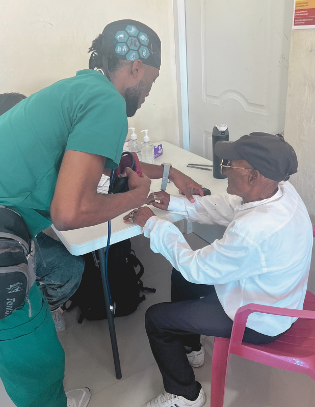 premed student intern working with a patient during abroad medical research internship