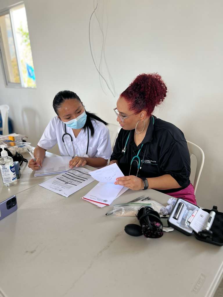 Global Health Leaders 1:1 Research Mentorship | Mentor and Student Collaboration Two healthcare professionals engaged in mentorship, reviewing documents and discussing clinical training, in a collaborative learning environment.